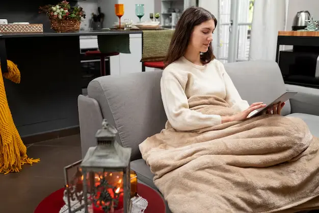 Reading on the sofa with a blanket on
